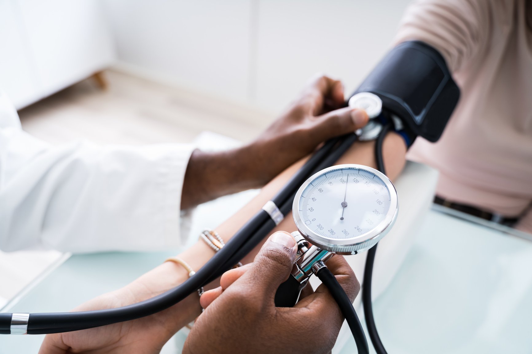 Doctor's Hand Checking Blood Pressure